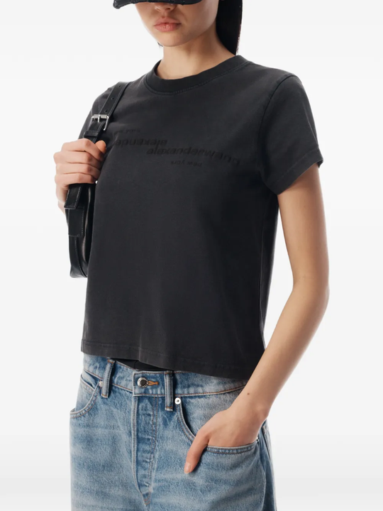 Black top worn by a person, showing the top fit