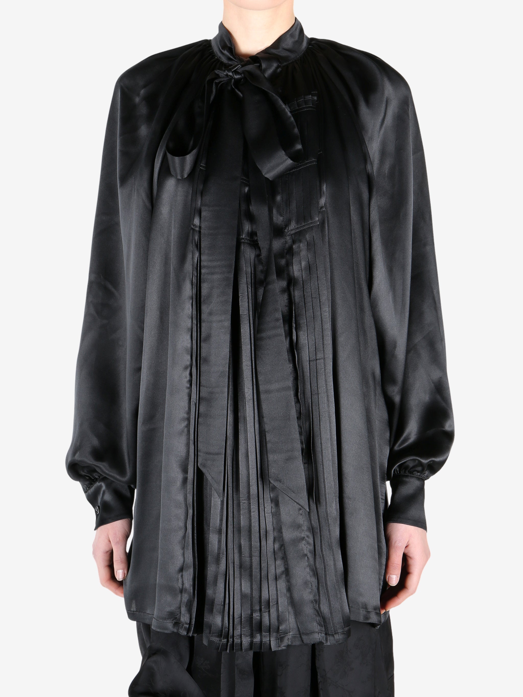 Black shirt worn by a person, showing the shirt fit