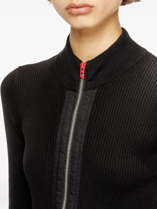 Close up of black knitwear, showing texture of the cotton fabric