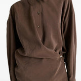 Brown shirt worn by a person, showing the shirt's fit
