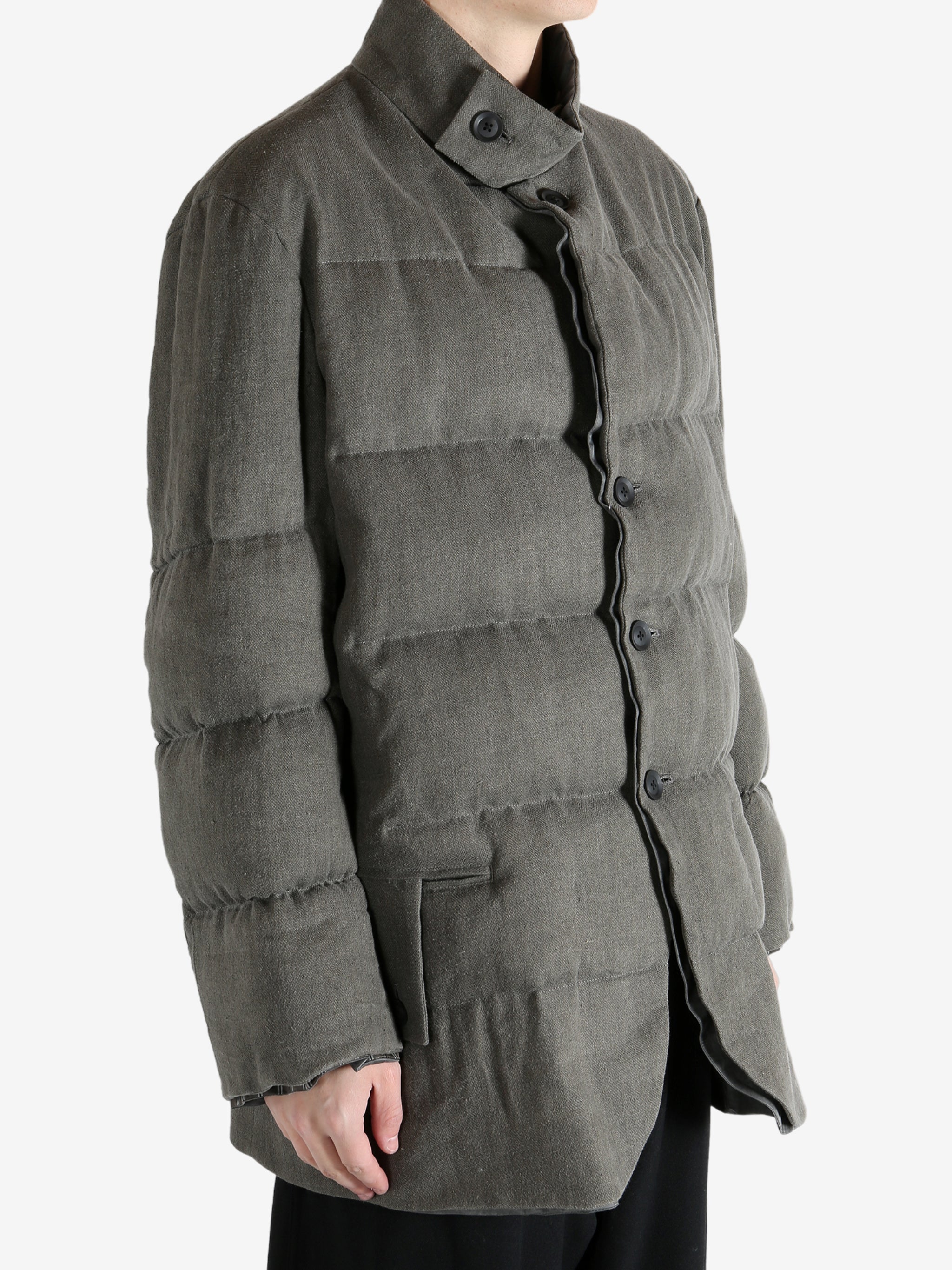 Grey jacket worn by a person, showing the jacket's fit