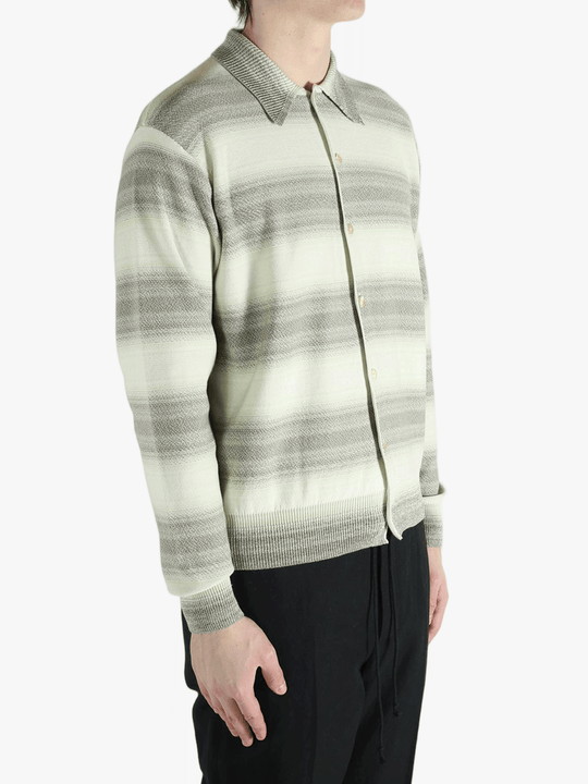 Grey knitwear worn by a person, showing the knitwear's fit
