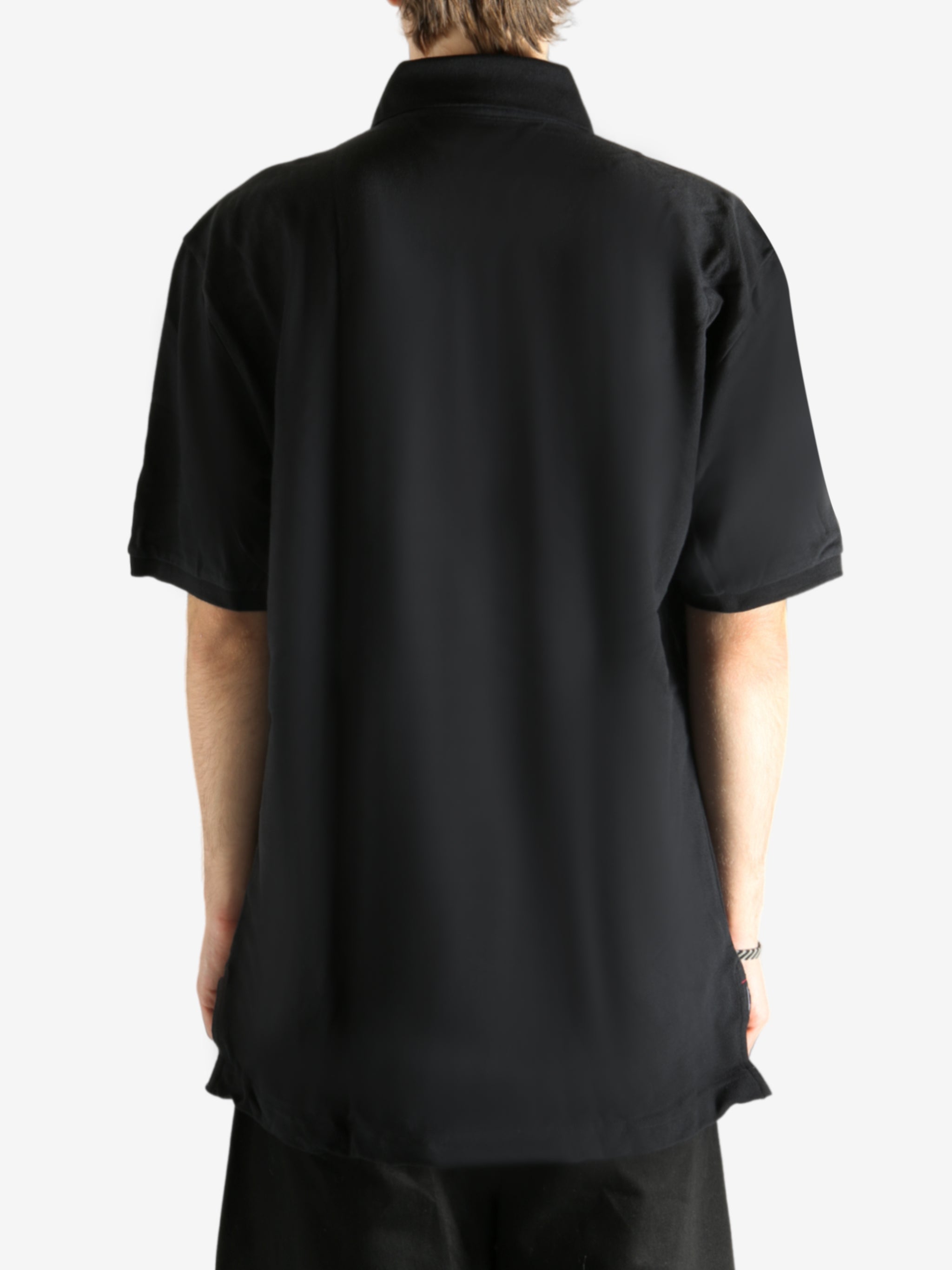 Black T-shirt worn by a person, showing the T-shirt's fit