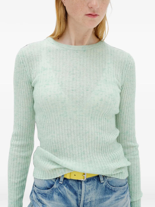 Green knitwear worn by a person, showing the knitwear fit