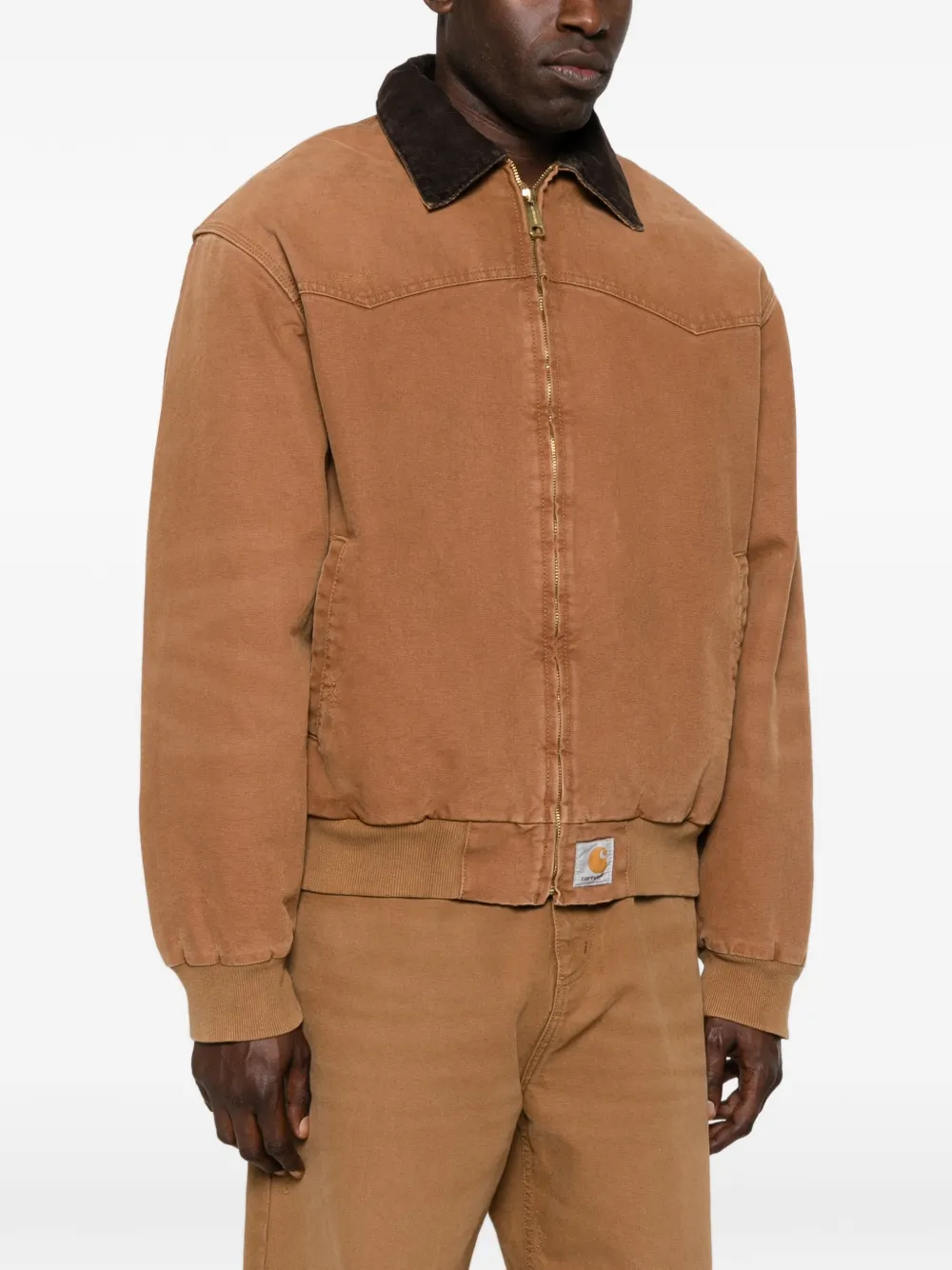 brown jackets-coats worn by a person, showing the jackets-coats fit