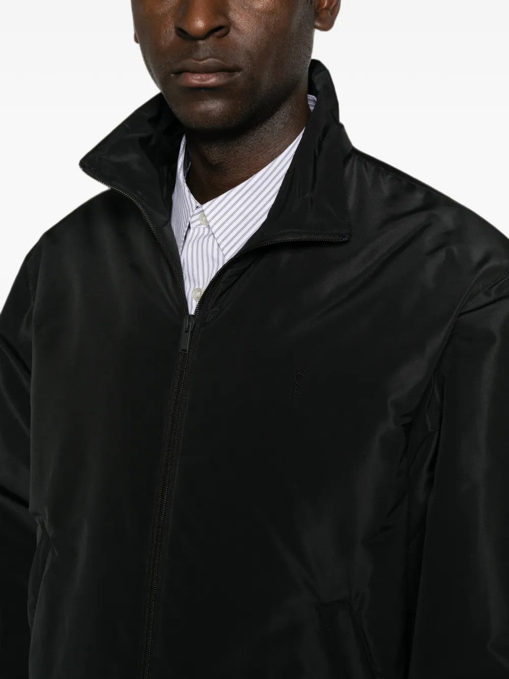Black jacket worn by a person, showing the jacket fit