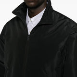 Black jacket worn by a person, showing the jacket fit
