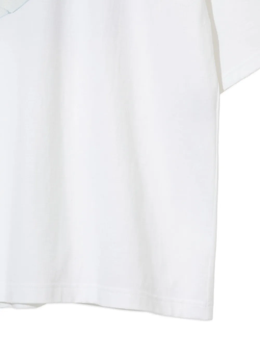 Close up of the white t-shirt, showing texture of the cotton fabric