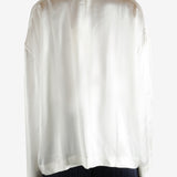 white long-sleeve shirt worn by a person, showing the shirt fit