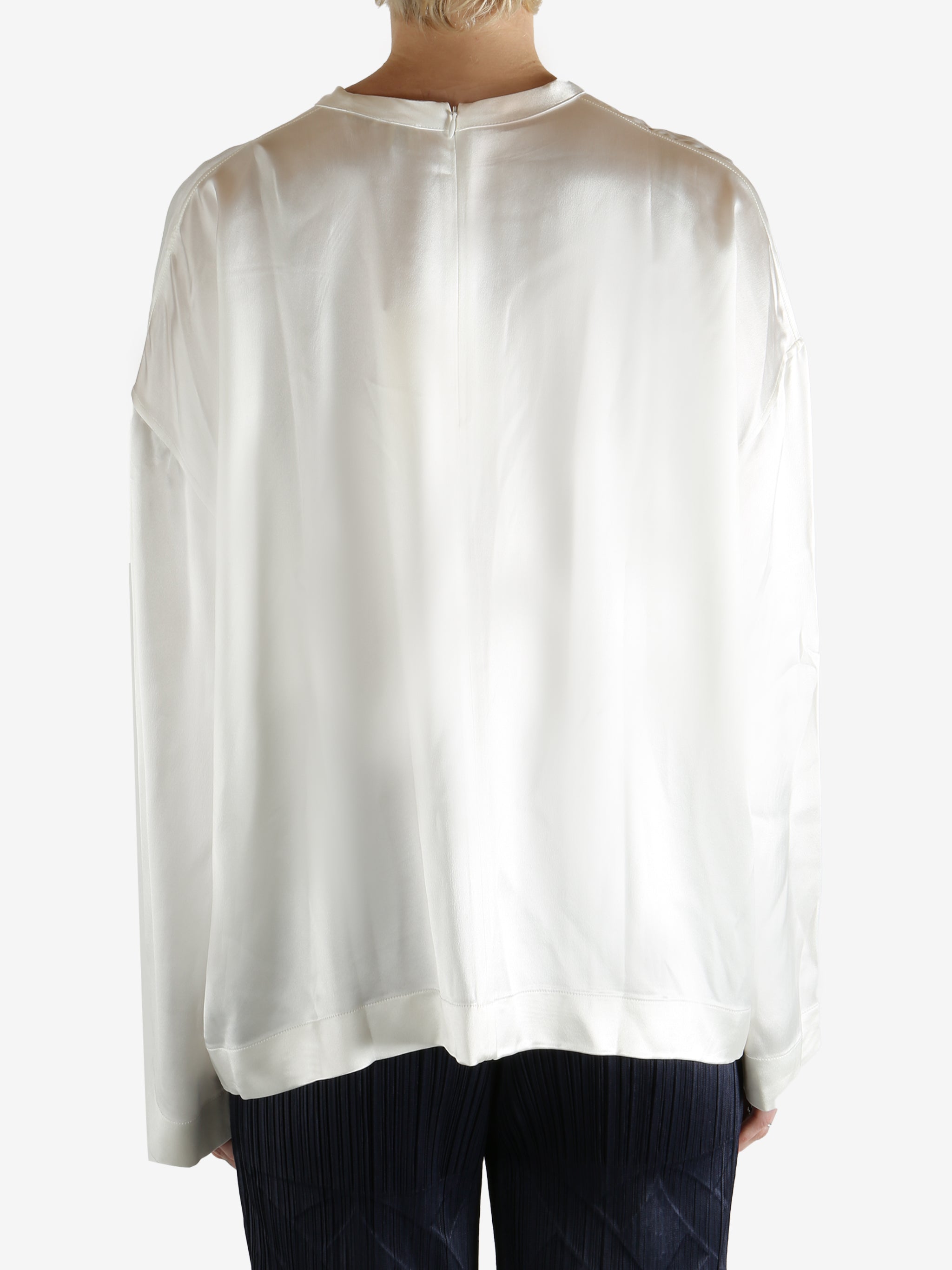 white long-sleeve shirt worn by a person, showing the shirt fit