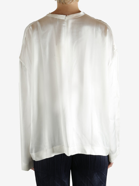 white long-sleeve shirt worn by a person, showing the shirt fit