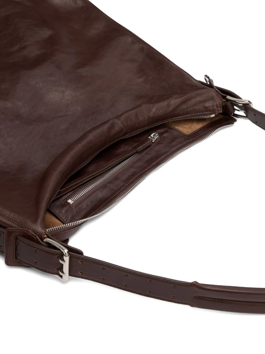 Close up of the brown bag, showing texture of the leather fabric