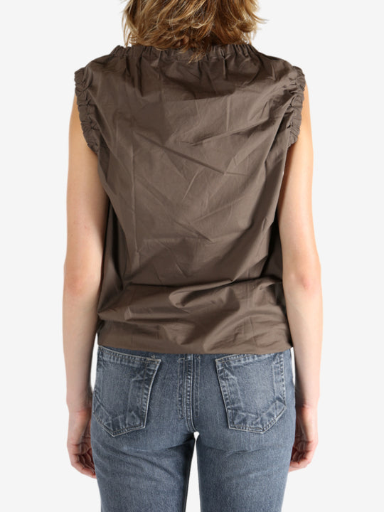 Brown top worn by a person, showing the top fit