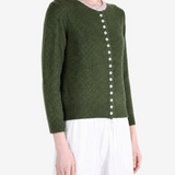 Green knitwear worn by a person, showing the knitwear fit