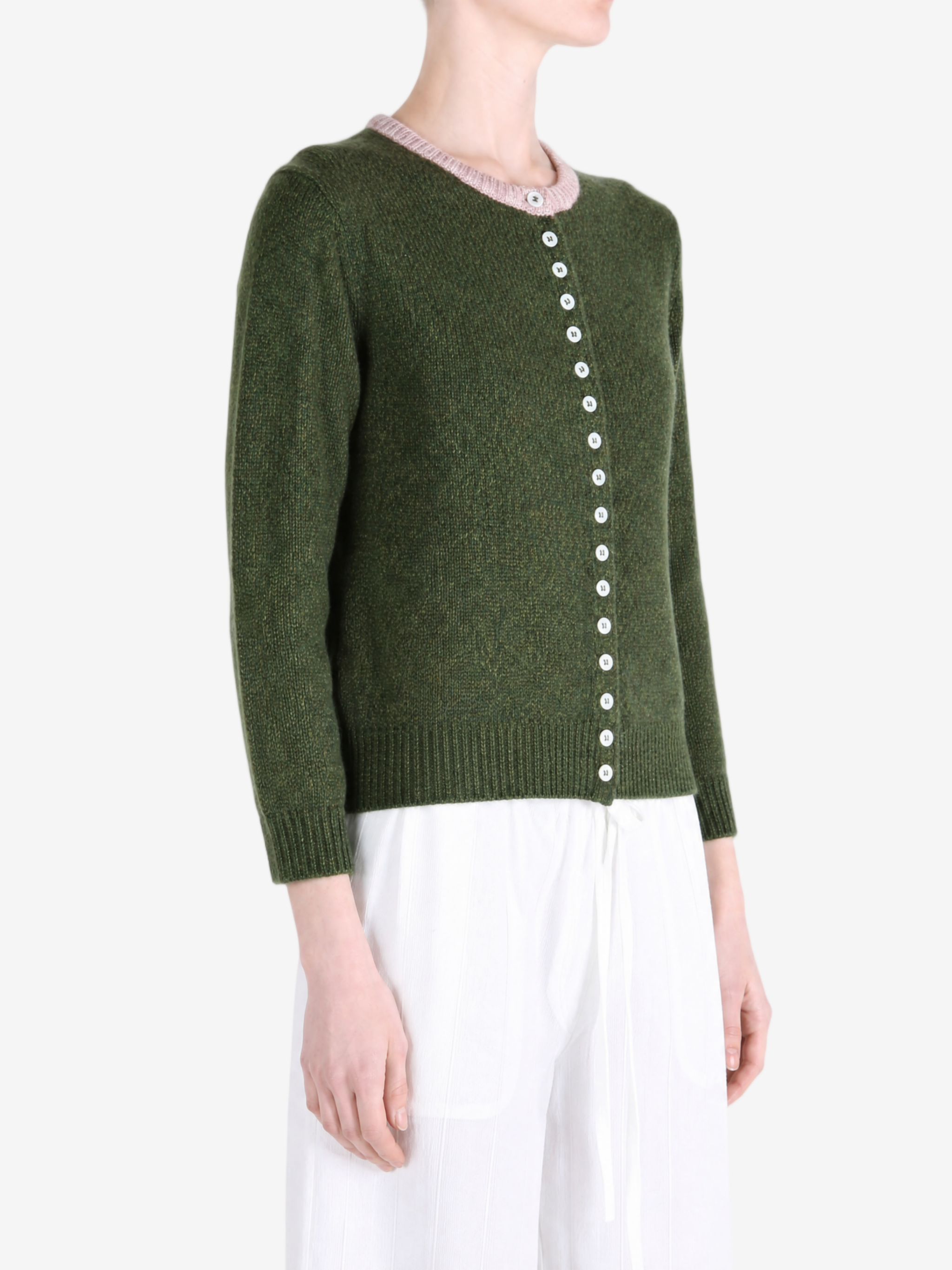 Green knitwear worn by a person, showing the knitwear fit