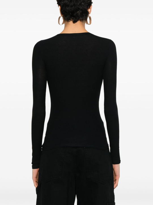 Black T-shirt worn by a person, showing the shirt’s fit