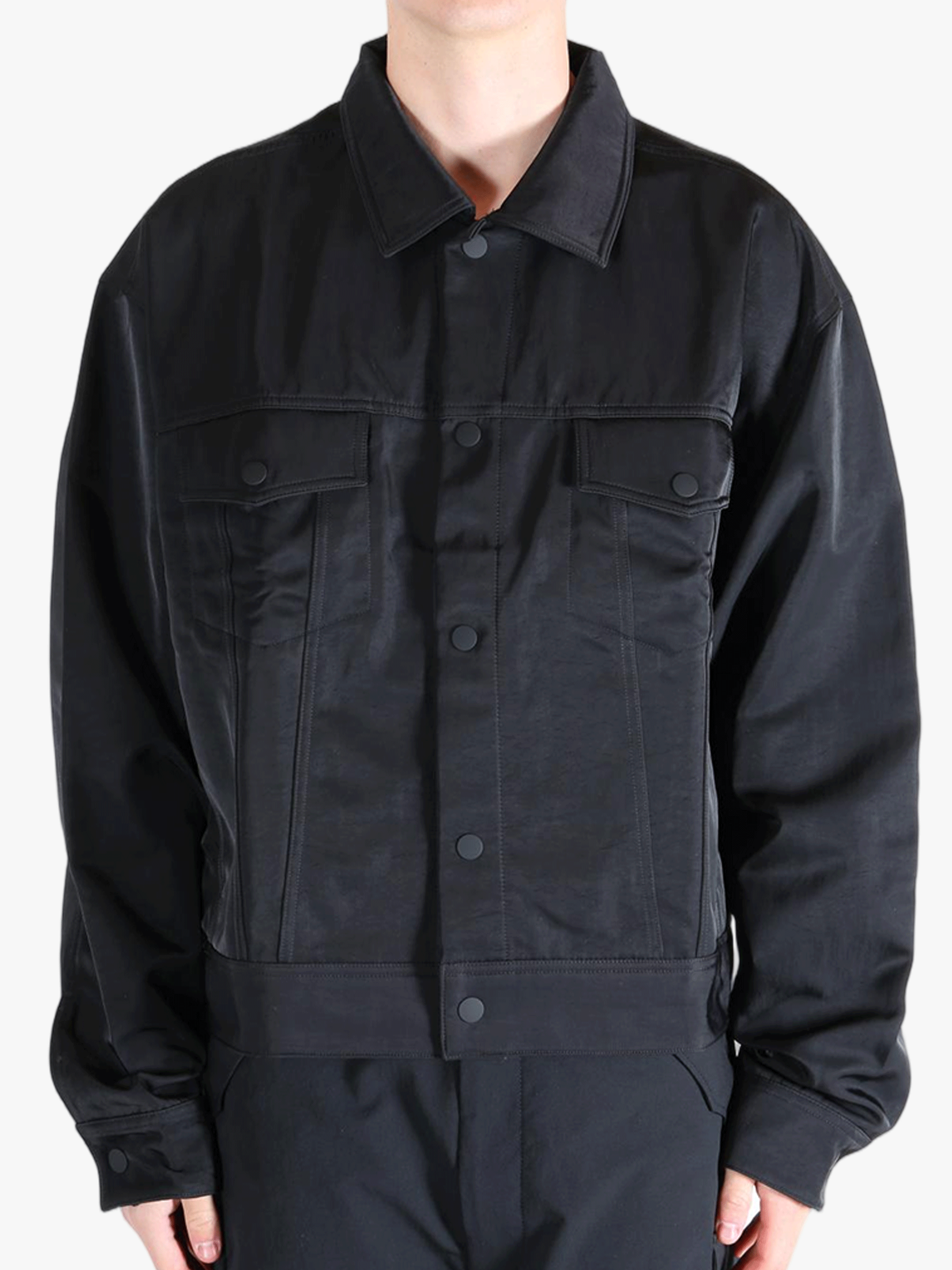 Black jacket worn by a person, showing the jackets fit