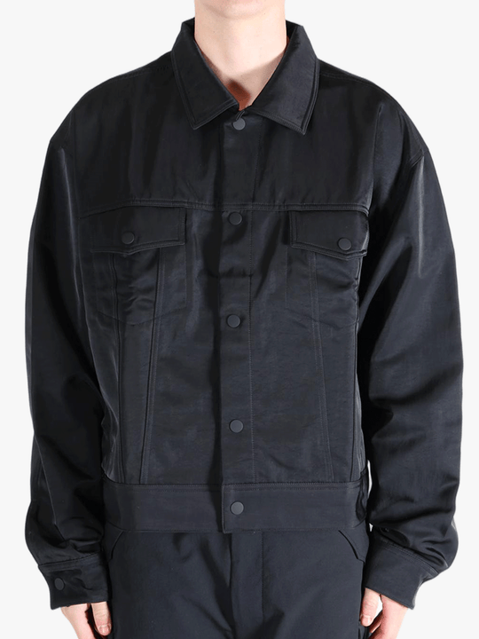 Black jacket worn by a person, showing the jackets fit