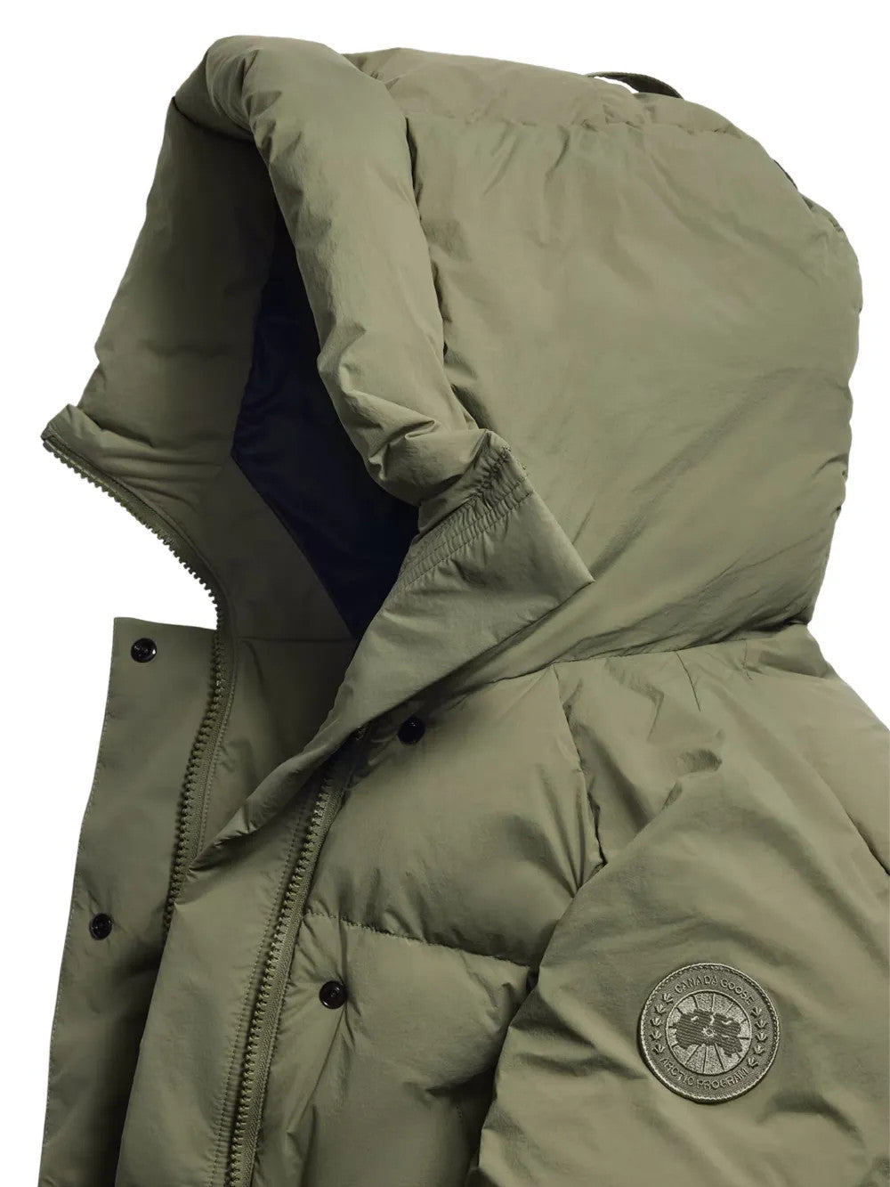 Close up of Green jacket, showing texture of the 100% recycled polyamide made fabric