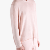 Light pink sweater,worn by a person, showing the sweater fit