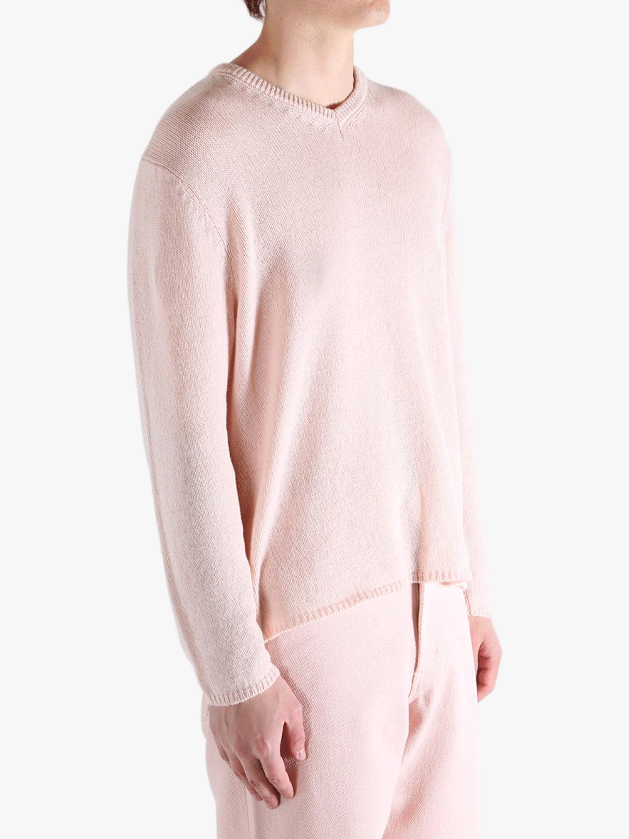 Light pink sweater,worn by a person, showing the sweater fit