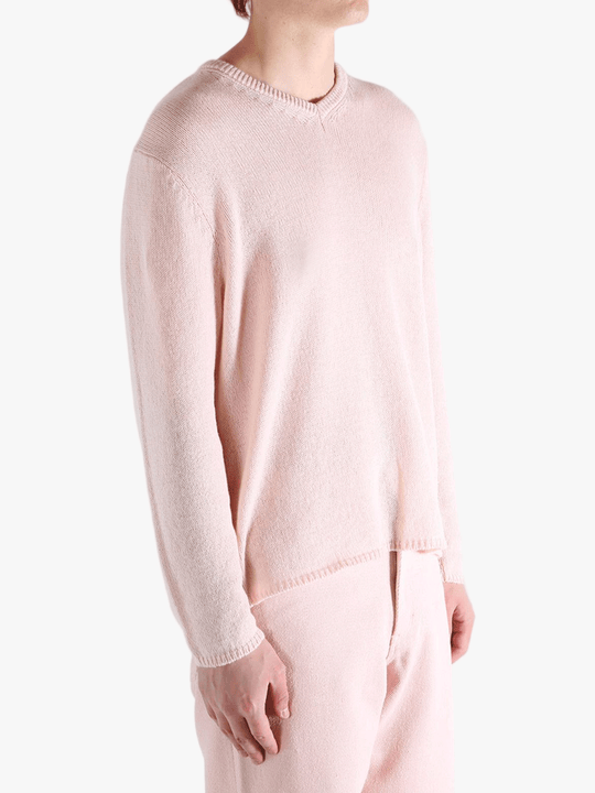 Light pink sweater,worn by a person, showing the sweater fit