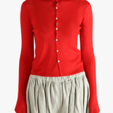 Red knitwear worn by a person, showing the knitwear's fit