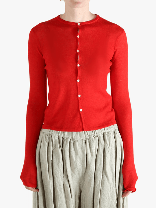 Red knitwear worn by a person, showing the knitwear's fit