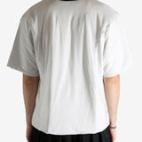 White t-shirt worn by a person, showing the shirt's fit
