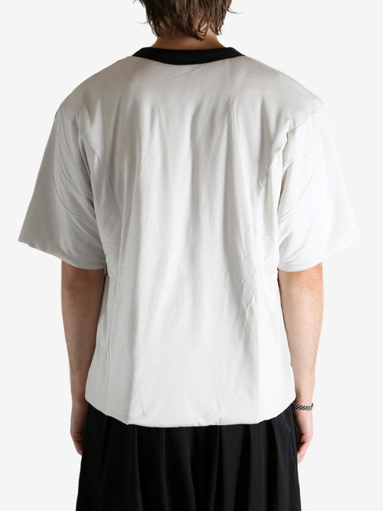 White t-shirt worn by a person, showing the shirt's fit