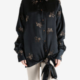 Black top worn by a person, showing the top's fit