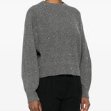 Grey knitwear worn by a person, showing the knitwear's fit