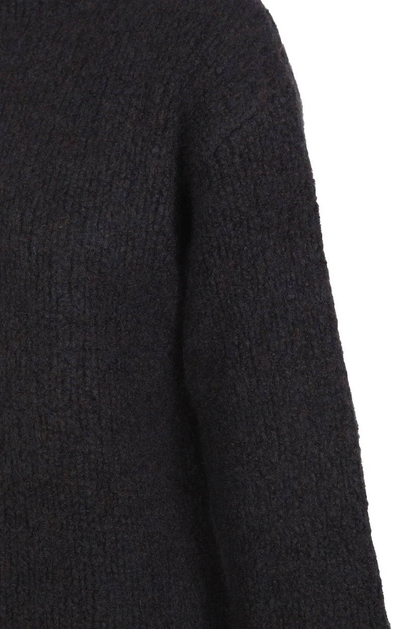 Close up of the navy knitwear, showing texture of the cashmere and wool fabric
