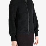 Black jacket worn by a person, showing the jacket fit