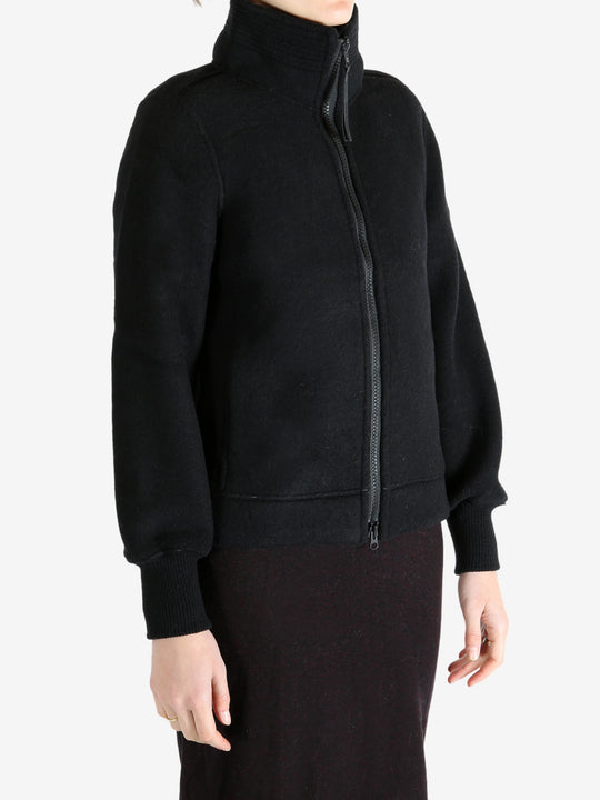 Black jacket worn by a person, showing the jacket fit