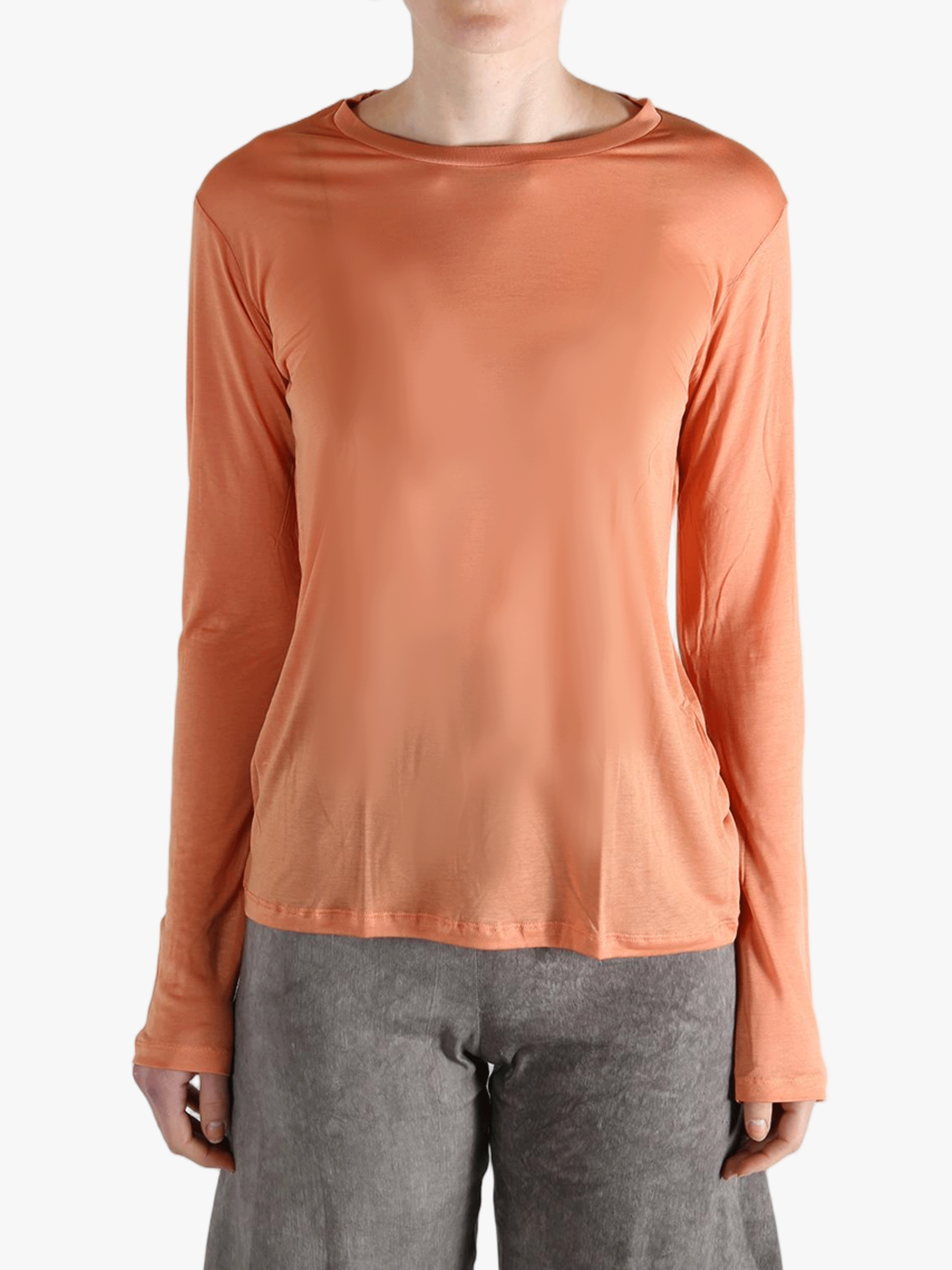Orange shirts worn by a person, showing the  shirt's  fit