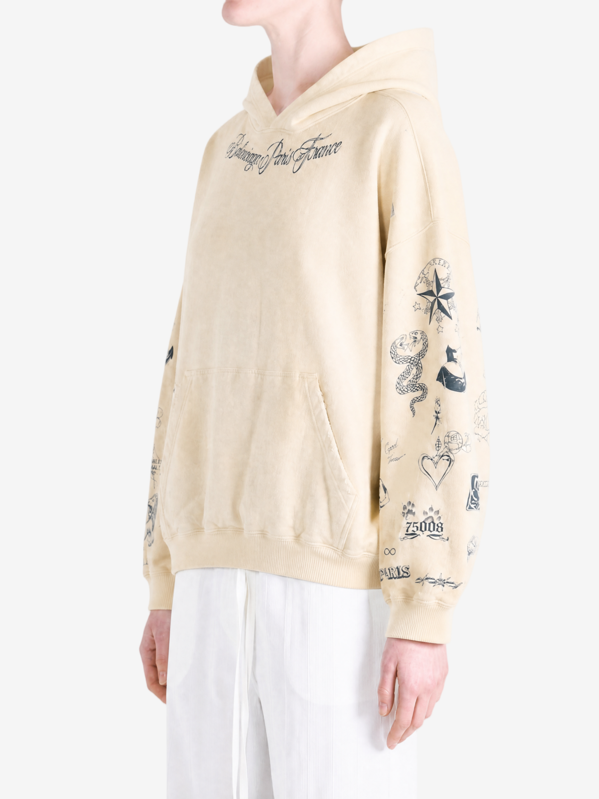 Tan hoodie worn by a person, showing the hoodie fit