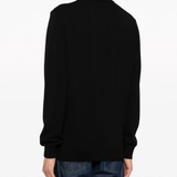 Black sweater worn by a person, showing the sweater fit