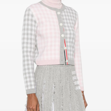 Grey knitwear worn by a person, showing the knitwear's fit