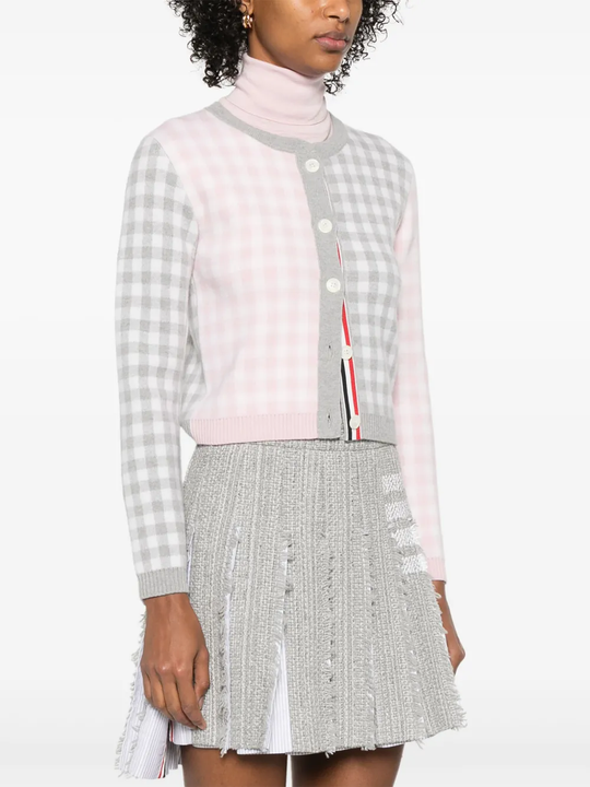 Grey knitwear worn by a person, showing the knitwear's fit