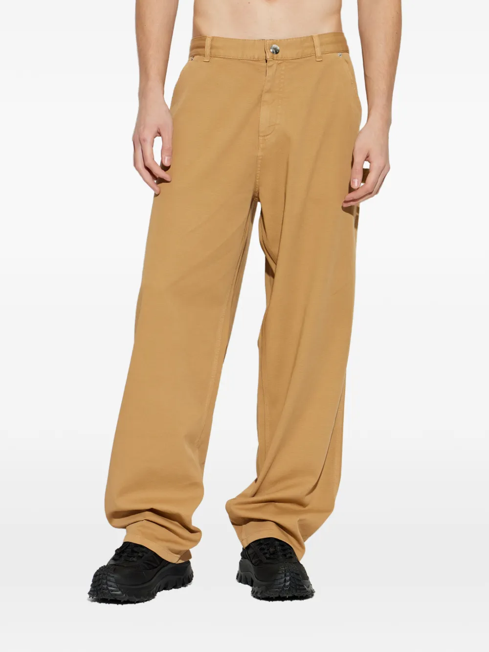 brown pants worn by a person, showing the pants fit
