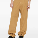 brown pants worn by a person, showing the pants fit