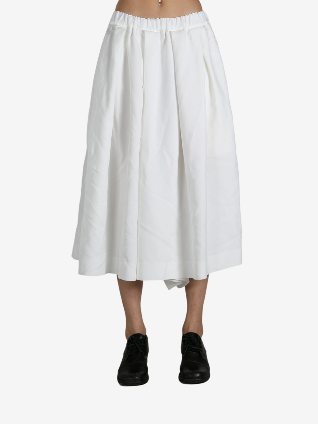 White pants worn by a person, showing the pants fit