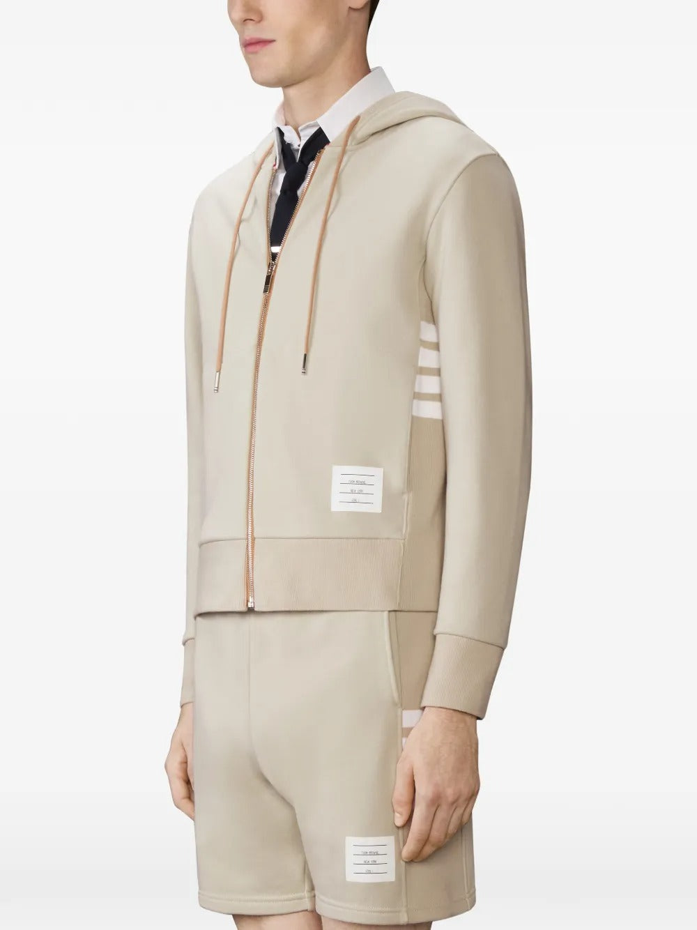 Tan hoodies worn by a person, showing the hoodies fit