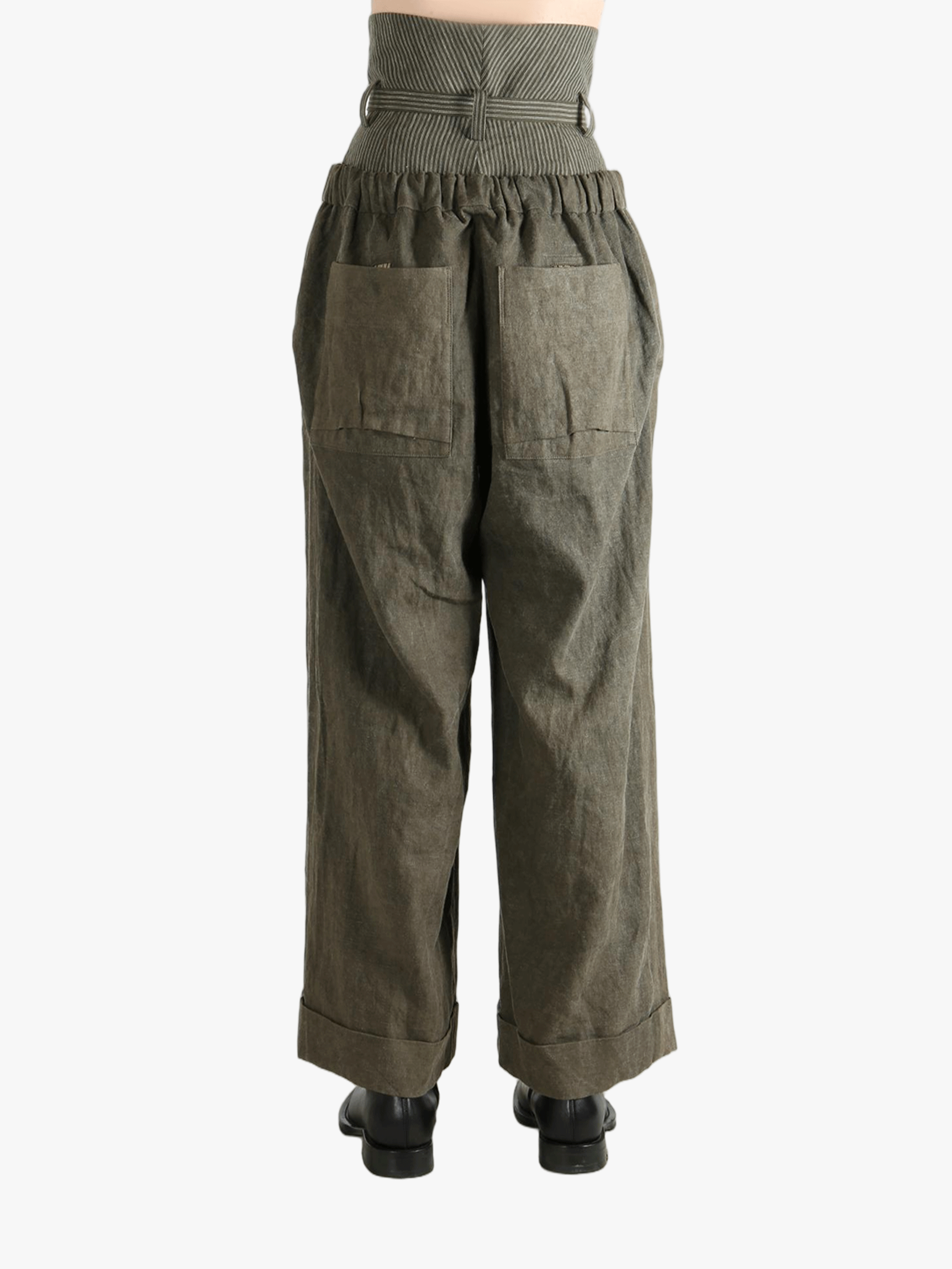 Green pants worn by a person, showing the pants' fit