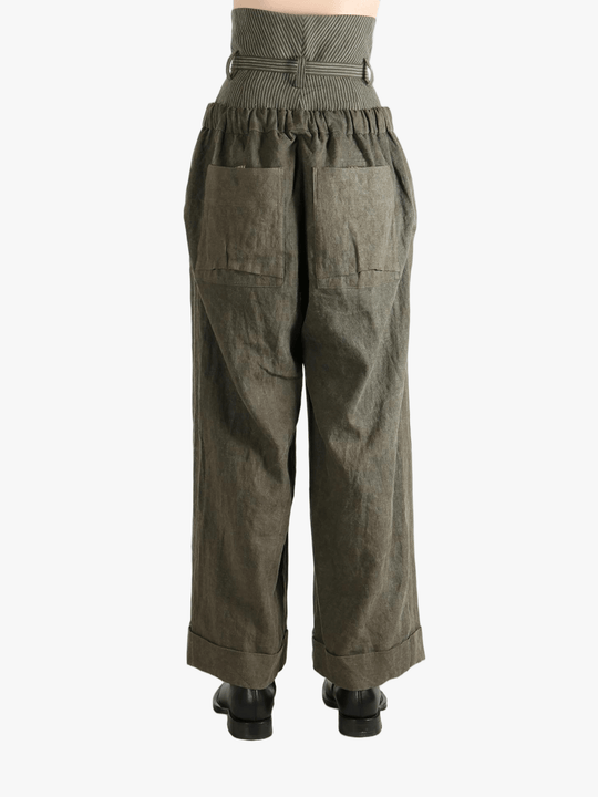 Green pants worn by a person, showing the pants' fit