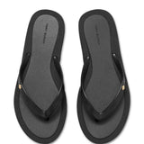 Close up of tan sandals, showing texture of the thermoplastic polyurethane and polyethylene vinyl acetate fabric