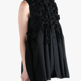 Black vest worn by a person, showing the vest's fit