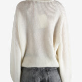 beige sweater worn by a person, showing the sweater fit