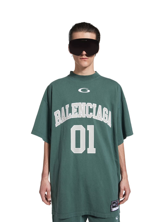 Green t-shirt worn by a person, showing the t-shirt's fit